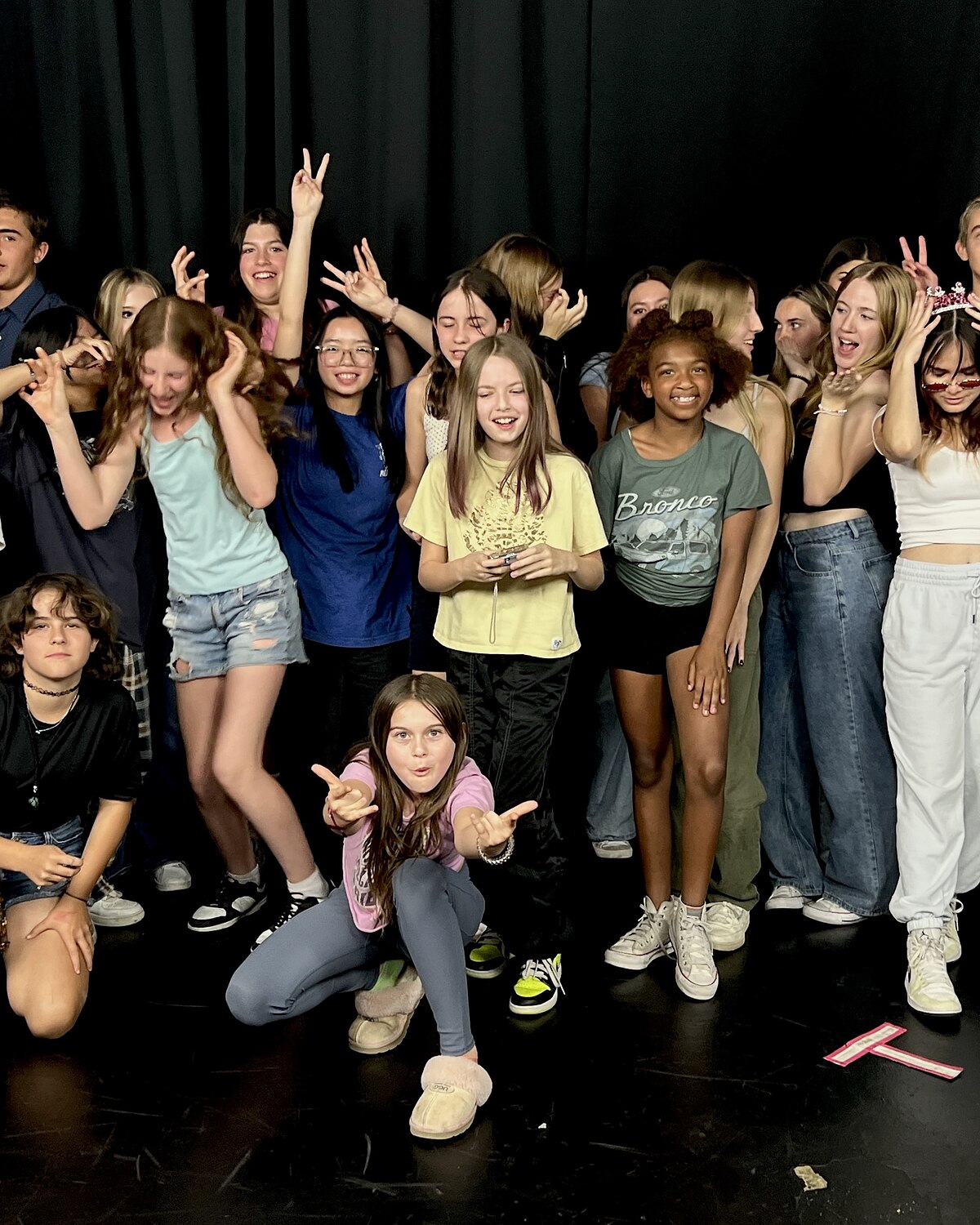 A teen class together on stage after showcase night at Dearing Acting Studio