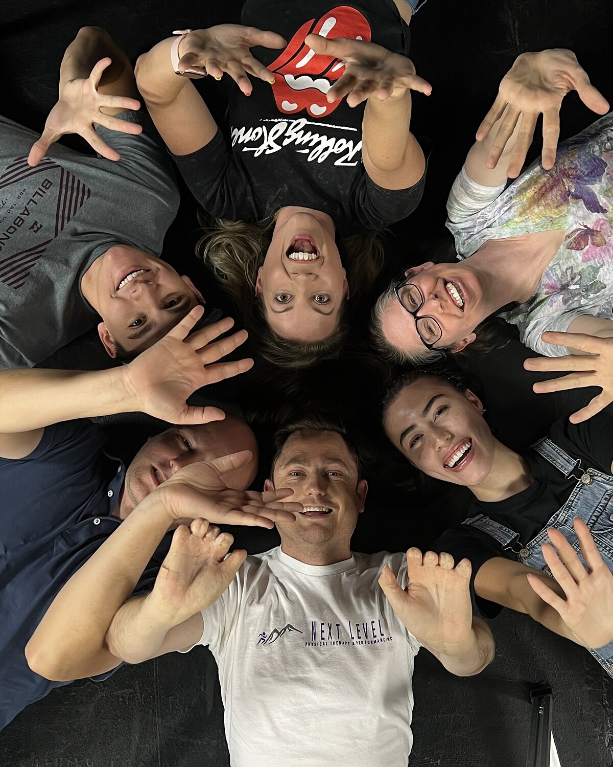 Adult improv players in a circle, seen from above, at Dearing Acting Studio