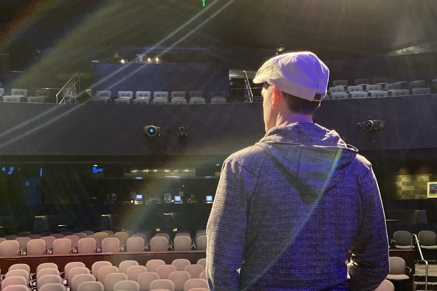 Matthew Dearing on stage before a keynote, facing the empty hall