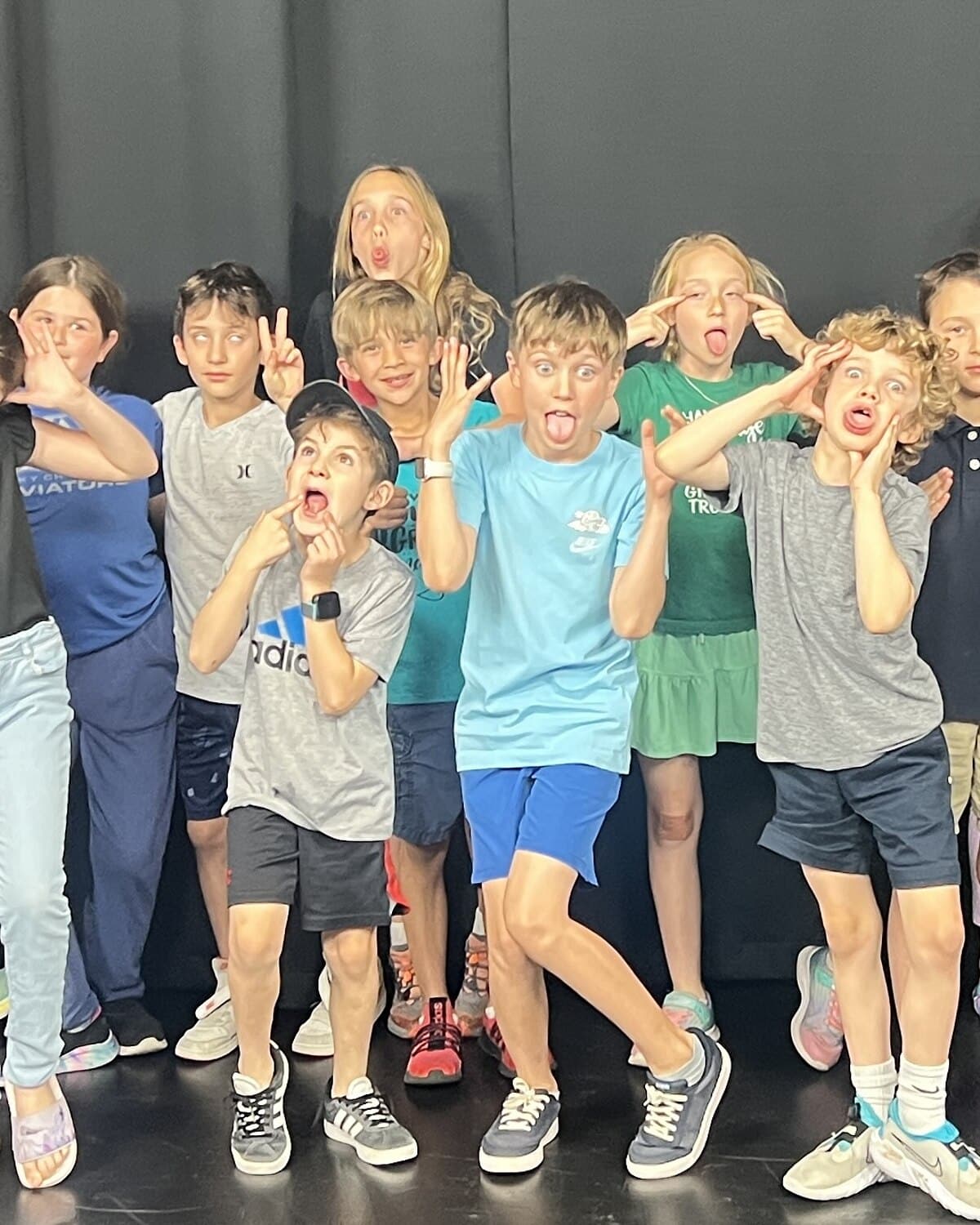 A row of kids in improv class making faces at the camera at Dearing Acting Studio