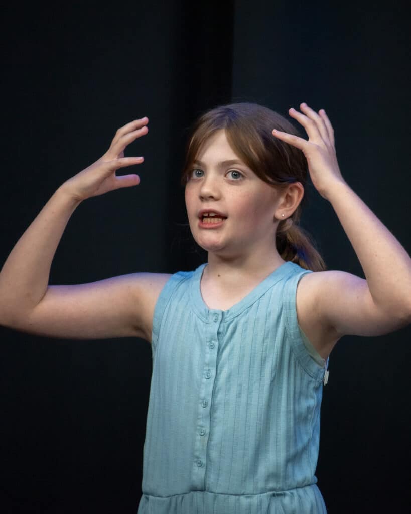 A student in the middle of an improv scene in the kid improv class at Dearing Acting Studio