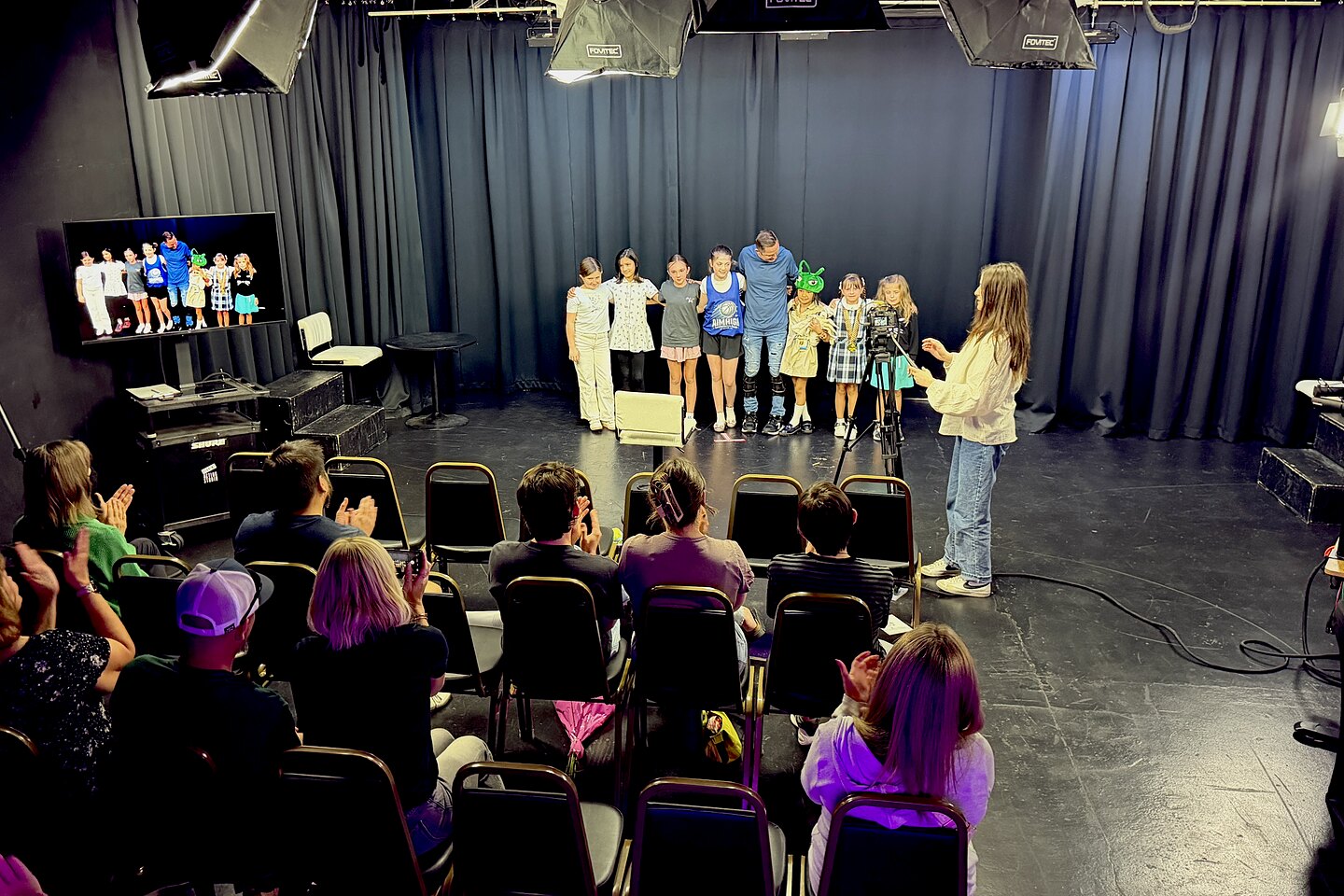 A kid script showcase at Dearing Acting Studio, the class on stage and families in the seats