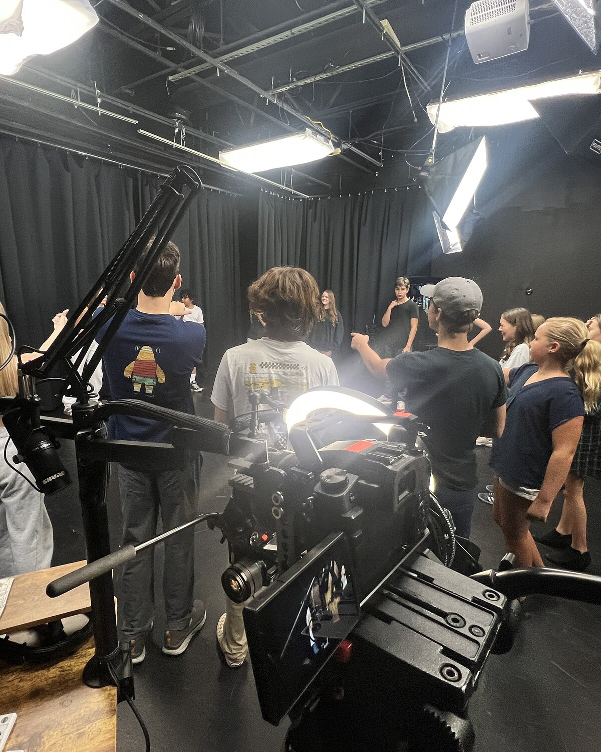 A teen improv student behind one of the four cameras at Dearing Acting Studio, the class on the other side